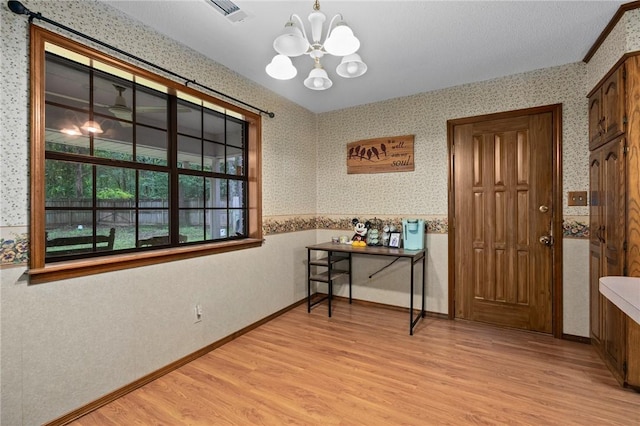 319 Belle Ave, Alma, AR 72921 - dining area featuring wallpapered walls, a chandelier, and light wood-style floors