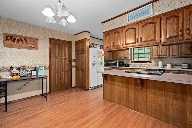 319 Belle Ave, Alma, AR 72921 - kitchen featuring white fridge with ice dispenser, wallpapered walls, light countertops, light wood-style flooring, and stovetop