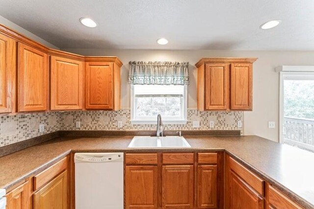 150 Cedar Wood Ave, Branson, MO 65616 - kitchen with dishwasher, decorative backsplash, recessed lighting, brown cabinetry, and dark countertops