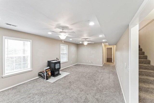 150 Cedar Wood Ave, Branson, MO 65616 - unfurnished living room with a wood stove, recessed lighting, ceiling fan, stairs, and carpet floors