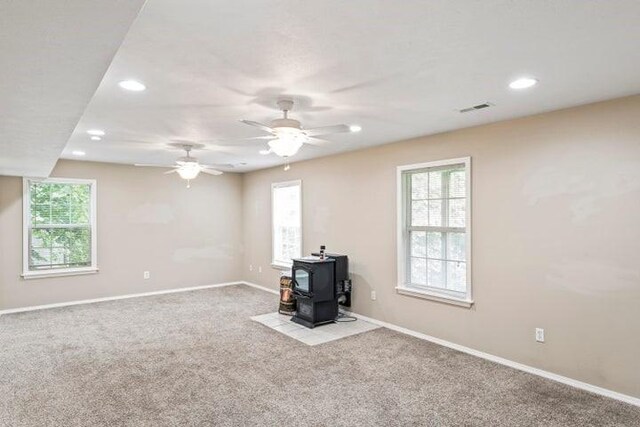 150 Cedar Wood Ave, Branson, MO 65616 - unfurnished living room with a wood stove, carpet flooring, plenty of natural light, recessed lighting, and a ceiling fan