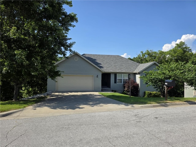 150 Cedar Wood Ave, Branson, MO 65616 - view of front of property with concrete driveway, a garage, and roof with shingles