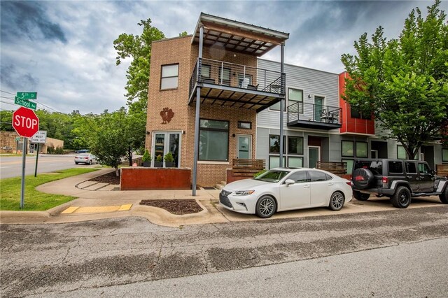 3901 W 5th St, Fayetteville, AR 72701 - view of front facade with brick siding and a balcony
