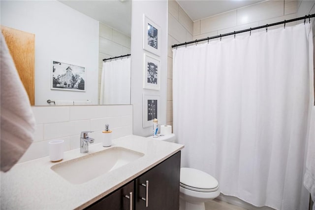 3901 W 5th St, Fayetteville, AR 72701 - bathroom with tasteful backsplash, vanity, curtained shower, and tile walls