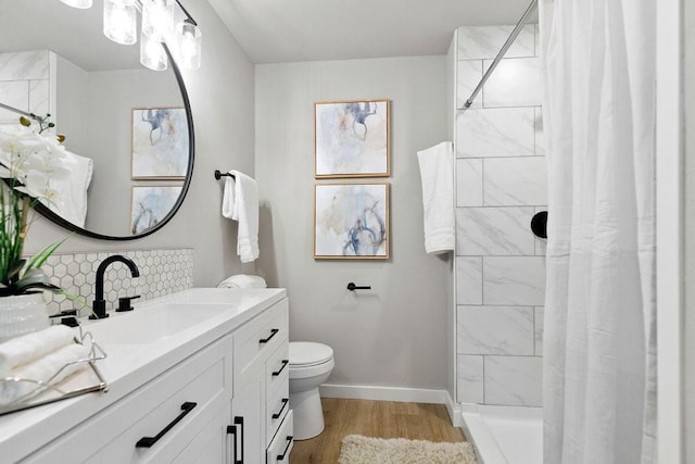 802 Hinshaw Dr, Springdale, AR 72762 - full bathroom featuring vanity, wood finished floors, decorative backsplash, and tiled shower