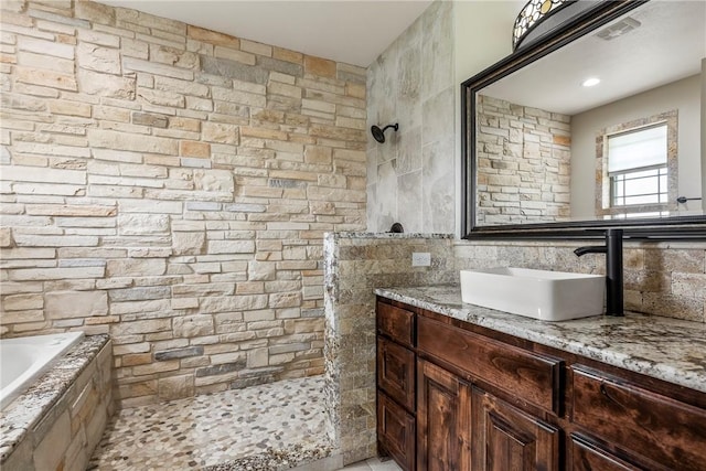11267 Walters Rd, Bentonville, AR 72712 - full bath featuring a walk in shower, vanity, tiled bath, and tile walls