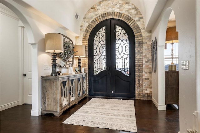 11267 Walters Rd, Bentonville, AR 72712 - foyer entrance featuring arched walkways, dark wood-type flooring, and french doors