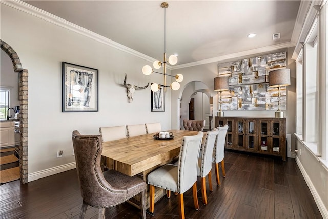 11267 Walters Rd, Bentonville, AR 72712 - dining space featuring arched walkways, plenty of natural light, dark wood finished floors, crown molding, and recessed lighting