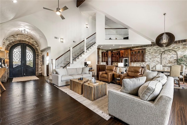 11267 Walters Rd, Bentonville, AR 72712 - living area with arched walkways, high vaulted ceiling, hardwood / wood-style flooring, french doors, and stairway