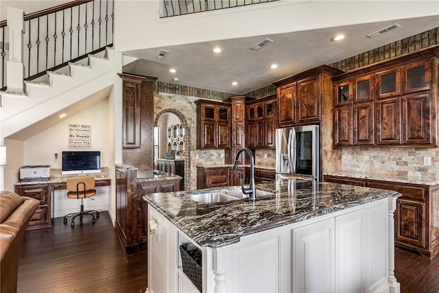 11267 Walters Rd, Bentonville, AR 72712 - kitchen with stainless steel refrigerator with ice dispenser, dark wood-style flooring, glass insert cabinets, a large island, and tasteful backsplash