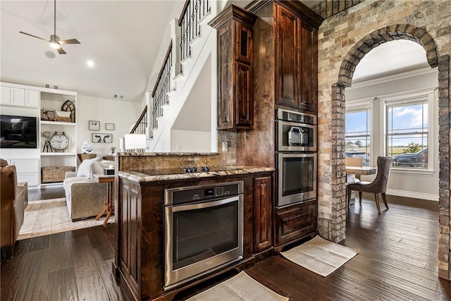 11267 Walters Rd, Bentonville, AR 72712 - kitchen featuring ornamental molding, dark wood-type flooring, light stone counters, dark brown cabinetry, and open floor plan
