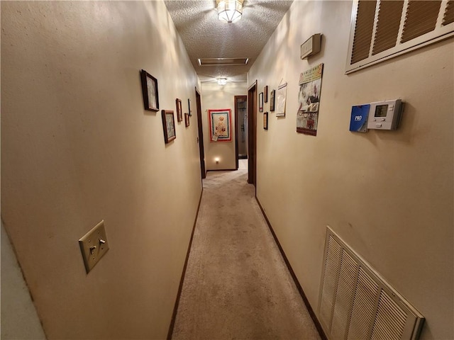 1805 Van Buren Ave, Mountain Home, AR 72653 - hallway featuring a textured ceiling, light carpet, and attic access