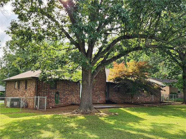 1805 Van Buren Ave, Mountain Home, AR 72653 - view of side of property featuring brick siding and a central air condition unit