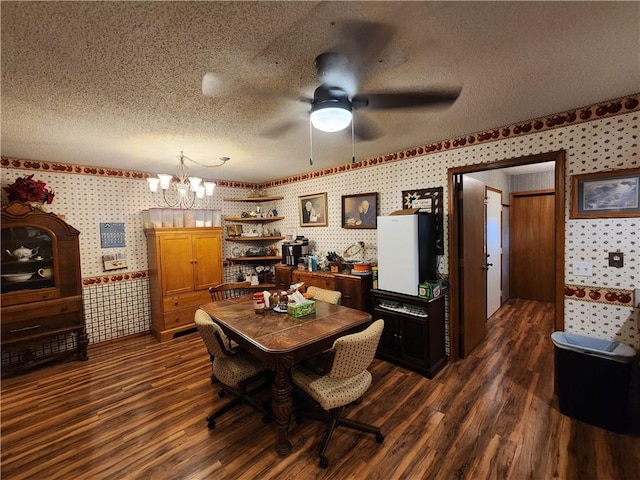 1805 Van Buren Ave, Mountain Home, AR 72653 - dining space featuring wallpapered walls, dark wood-type flooring, a chandelier, a ceiling fan, and a textured ceiling