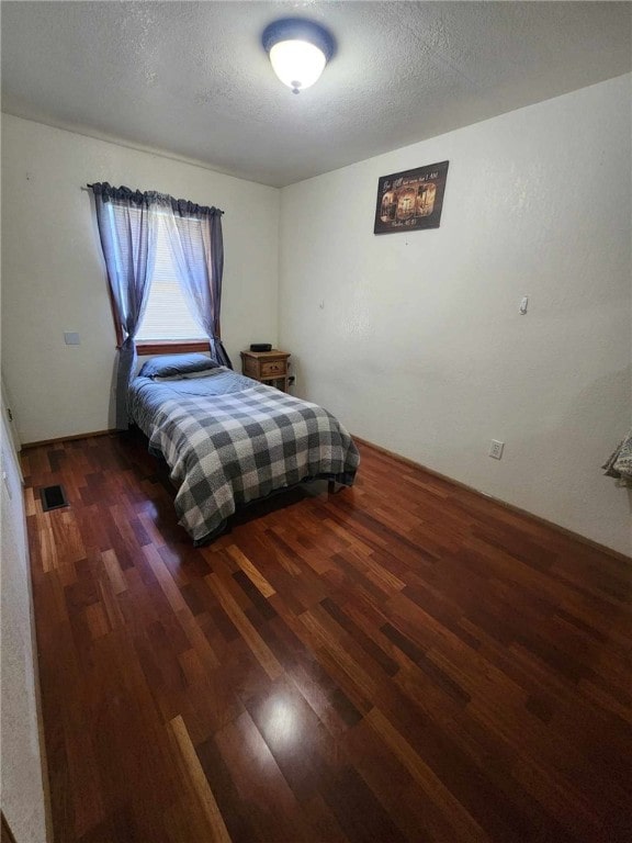 46 Hathcoat Rd, Harrison, AR 72601 - bedroom with wood finished floors and a textured ceiling