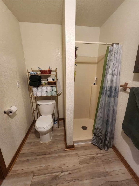 46 Hathcoat Rd, Harrison, AR 72601 - full bathroom featuring wood finished floors, a stall shower, and a textured wall