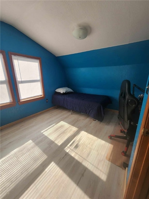 46 Hathcoat Rd, Harrison, AR 72601 - unfurnished bedroom featuring lofted ceiling, wood finished floors, and a textured ceiling