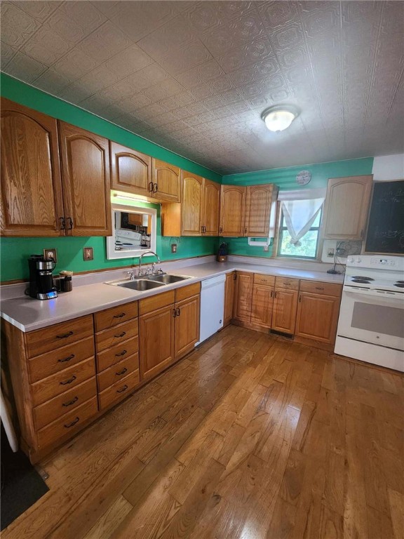 46 Hathcoat Rd, Harrison, AR 72601 - kitchen with white appliances, hardwood / wood-style flooring, light countertops, and brown cabinets