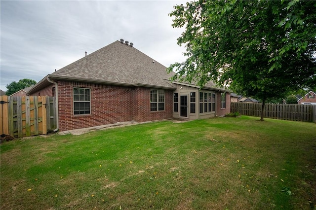 3402 Crosswinds Blvd, Bentonville, AR 72713 - rear view of property with brick siding, roof with shingles, and a fenced backyard