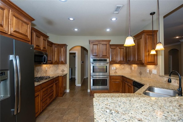 3402 Crosswinds Blvd, Bentonville, AR 72713 - kitchen with appliances with stainless steel finishes, arched walkways, light tile patterned floors, tasteful backsplash, and recessed lighting