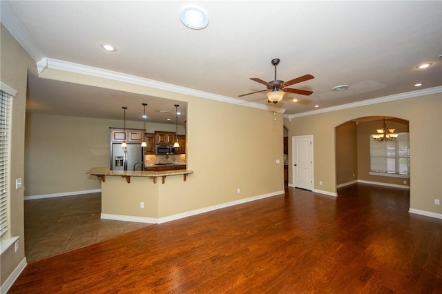 3402 Crosswinds Blvd, Bentonville, AR 72713 - unfurnished living room with a chandelier, ceiling fan, arched walkways, ornamental molding, and recessed lighting