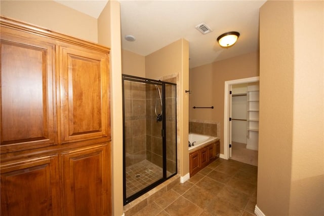 3402 Crosswinds Blvd, Bentonville, AR 72713 - full bath with a stall shower, a bath, tile patterned flooring, and a spacious closet