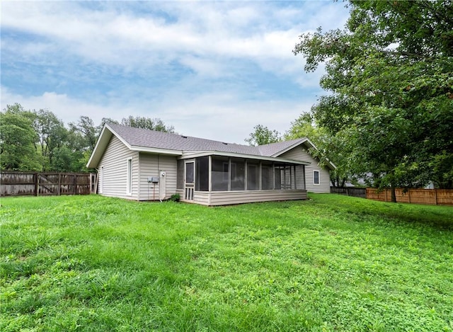 2176 Orchard Hill Rd, Siloam Springs, AR 72761 - back of house with a sunroom, a fenced backyard, and roof with shingles