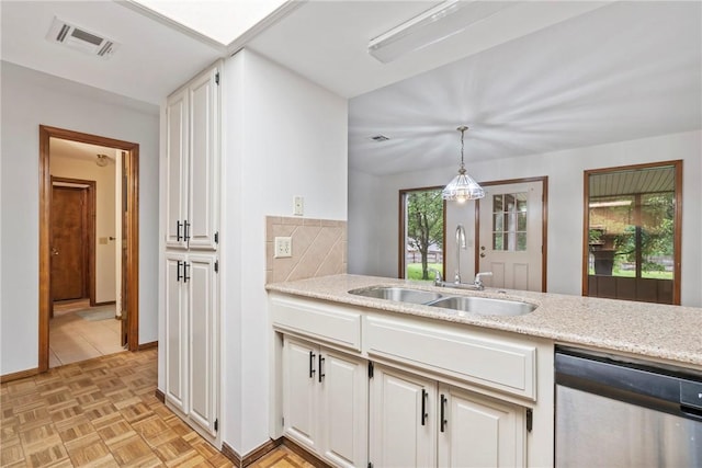 2176 Orchard Hill Rd, Siloam Springs, AR 72761 - kitchen with stainless steel dishwasher, hanging light fixtures, white cabinets, light stone countertops, and tasteful backsplash