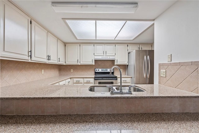 2176 Orchard Hill Rd, Siloam Springs, AR 72761 - kitchen featuring stainless steel appliances, under cabinet range hood, light stone countertops, a peninsula, and backsplash