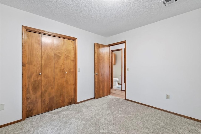 2176 Orchard Hill Rd, Siloam Springs, AR 72761 - unfurnished bedroom with carpet floors, a closet, and a textured ceiling