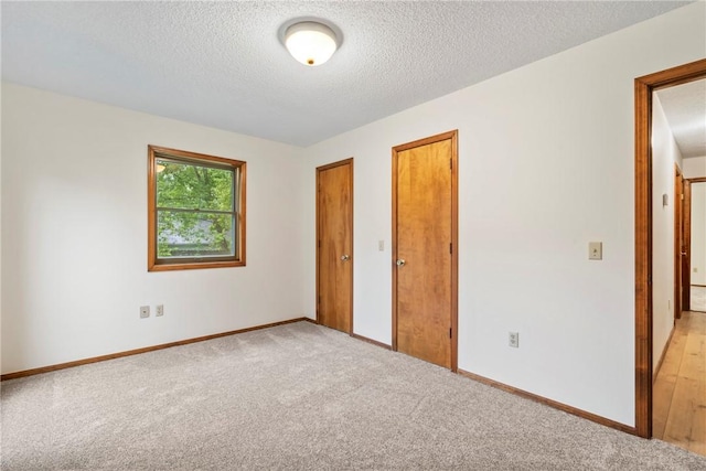 2176 Orchard Hill Rd, Siloam Springs, AR 72761 - unfurnished bedroom with a textured ceiling and light carpet
