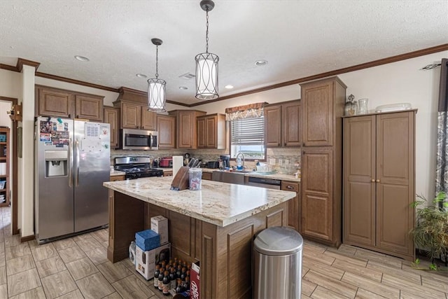21018 Farm Rd Unit 2260, Eagle Rock, MO 65641 - kitchen featuring stainless steel appliances, ornamental molding, backsplash, decorative light fixtures, and a center island