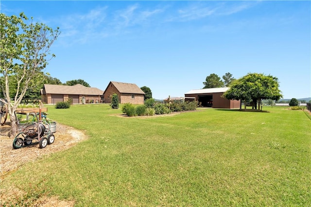 460 Viney Grove Rd, Prairie Grove, AR 72753 - view of grassy yard featuring an outbuilding and a detached garage