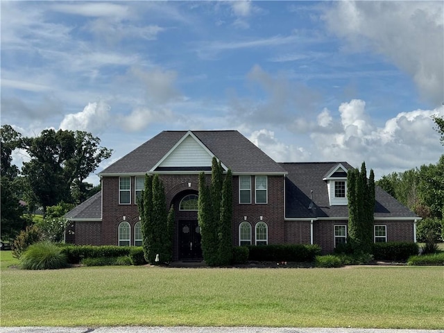 9739 Soaring Hawk Dr, Bentonville, AR 72713 - traditional-style house with brick siding, a front yard, and a shingled roof