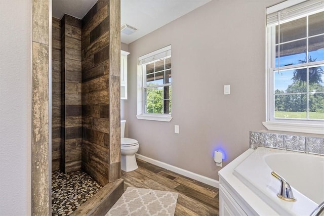 2042 Greasy Creek Ln, Washburn, MO 65772 - bathroom with a garden tub, wood finished floors, and a tile shower