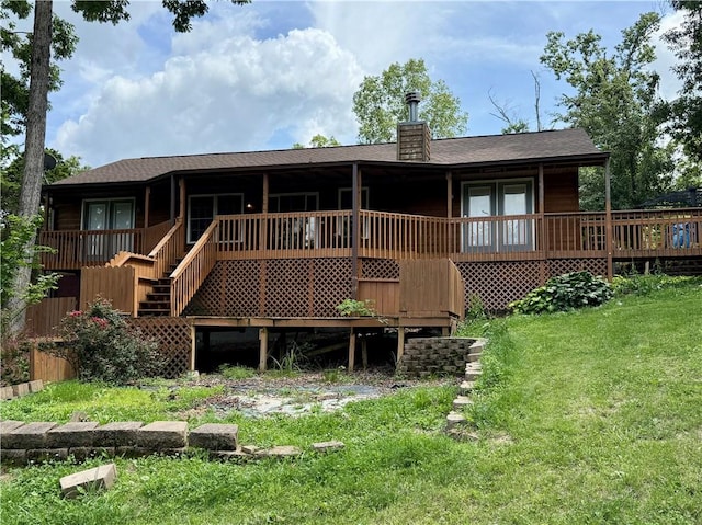 14076 Canal St, Rogers, AR 72758 - back of house featuring a lawn, a chimney, roof with shingles, and a wooden deck
