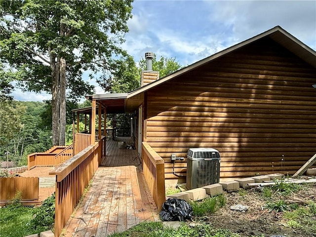 14076 Canal St, Rogers, AR 72758 - view of property exterior featuring a chimney, a wooden deck, and faux log siding
