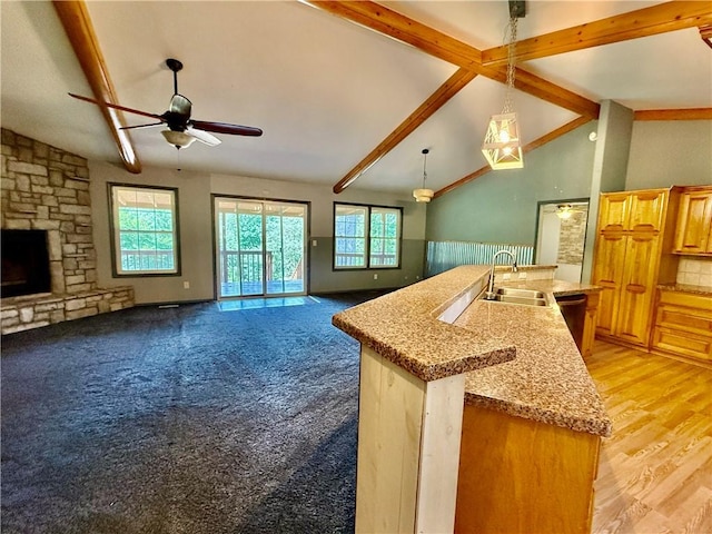 14076 Canal St, Rogers, AR 72758 - kitchen featuring open floor plan, a ceiling fan, beamed ceiling, a center island with sink, and decorative light fixtures
