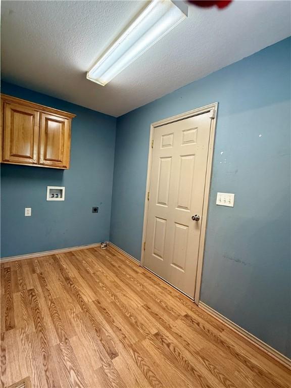 14076 Canal St, Rogers, AR 72758 - washroom with cabinet space, hookup for a washing machine, light wood finished floors, a textured ceiling, and hookup for an electric dryer