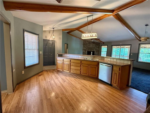 14076 Canal St, Rogers, AR 72758 - kitchen with dishwasher, a stone fireplace, brown cabinets, open floor plan, and light wood-style flooring
