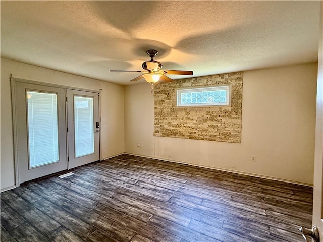 14076 Canal St, Rogers, AR 72758 - empty room featuring a textured ceiling, ceiling fan, healthy amount of natural light, and dark wood-type flooring