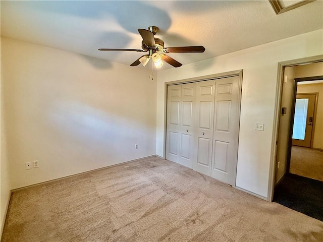 14076 Canal St, Rogers, AR 72758 - unfurnished bedroom with carpet flooring, a closet, and a ceiling fan