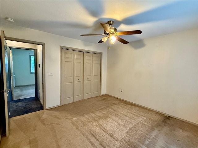 14076 Canal St, Rogers, AR 72758 - unfurnished bedroom featuring light carpet, a closet, and a ceiling fan