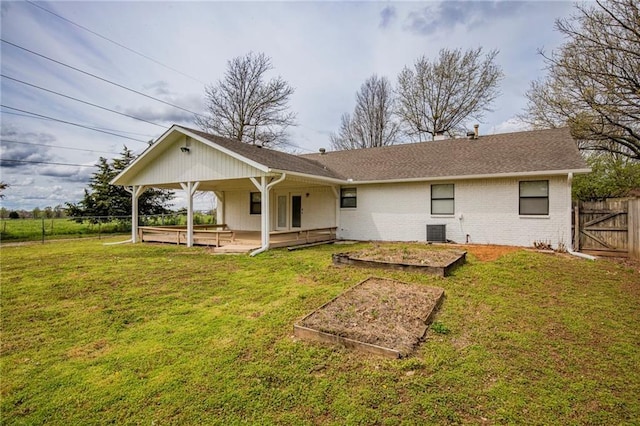 5315 Walden St, Lowell, AR 72745 - back of house with a garden, brick siding, and a shingled roof
