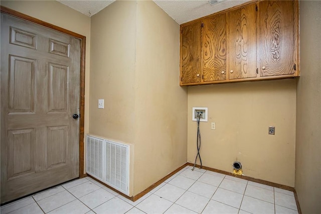 5315 Walden St, Lowell, AR 72745 - laundry area featuring cabinet space, hookup for a washing machine, electric dryer hookup, and light tile patterned flooring