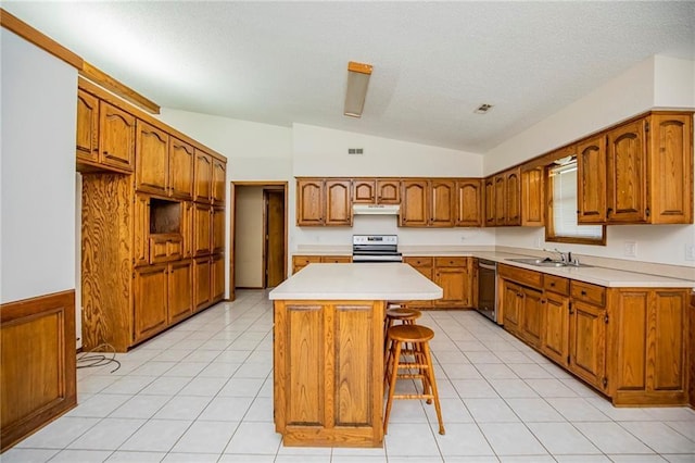 5315 Walden St, Lowell, AR 72745 - kitchen featuring stainless steel appliances, vaulted ceiling, brown cabinetry, a center island, and under cabinet range hood