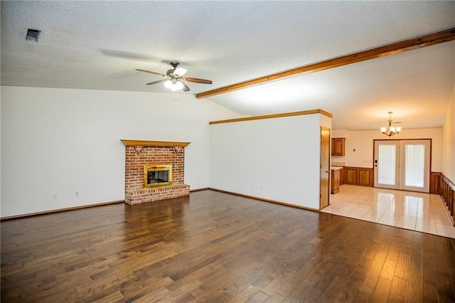 5315 Walden St, Lowell, AR 72745 - unfurnished living room featuring a ceiling fan, light wood-style floors, a chandelier, a textured ceiling, and a fireplace