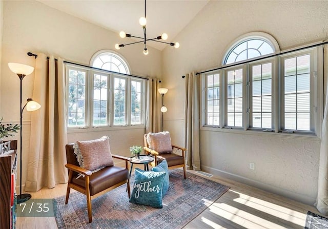 5 Horseshoe Dr, Holiday Island, AR 72631 - living area with plenty of natural light, a chandelier, vaulted ceiling, and wood finished floors