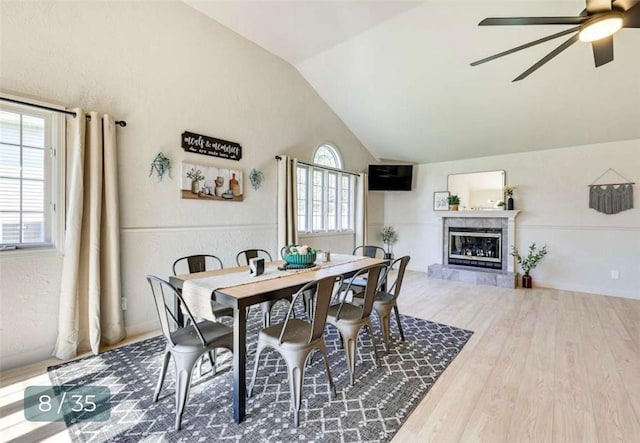 5 Horseshoe Dr, Holiday Island, AR 72631 - dining area with vaulted ceiling, a ceiling fan, wood finished floors, and a tile fireplace