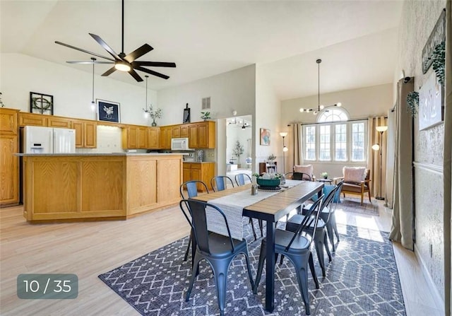 5 Horseshoe Dr, Holiday Island, AR 72631 - dining space with high vaulted ceiling, light wood finished floors, and ceiling fan